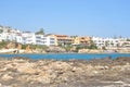 Rocks on the shore of the sea and the city of Hersonissos.