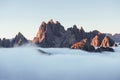 Rocks sleeping under all-encompassing mist. The peaks of the mountains stifle from a going thick fog. Unbelievable photo