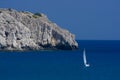 Rocks and small sailboat