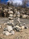 Rocks stacked on ground by stone cliff wall at state park