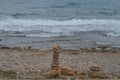 Rocks or stone balancing tower with Rocky Beach and sea background Royalty Free Stock Photo