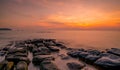 Rocks on stone beach at sunset. Beautiful beach sunset sky. Twilight sea and sky. Tropical sea at dusk. Dramatic sky and clouds. Royalty Free Stock Photo