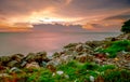 Rocks on stone beach at sunset. Beautiful beach sunset sky. Twilight sea and sky. Tropical sea at dusk. Romantic sky and clouds. Royalty Free Stock Photo