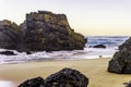 Rocks and stones at sandy beach at sunrise, Portugal Royalty Free Stock Photo