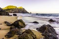 Rocks and stones at sandy beach at sunrise, Portugal Royalty Free Stock Photo