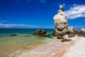 Rocks and stones of unusual bizarre shape on the sandy seashore with shells at clear day Royalty Free Stock Photo