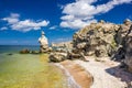 Rocks and stones of unusual bizarre shape on sea and sandy seashore at clear day Royalty Free Stock Photo