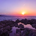 Rocks and their reflection in the sea at sunrise Royalty Free Stock Photo