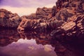 Rocks and their reflection in the sea at sunrise Royalty Free Stock Photo