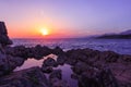 Rocks and their reflection in the sea at sunrise Royalty Free Stock Photo