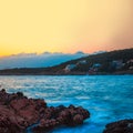 Rocks and their reflection in the sea at sunrise Royalty Free Stock Photo