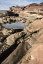 Rocks and tourists on cliff at Hilbre Island, West Kirby, Wirral, England Royalty Free Stock Photo