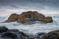 Rocks on Tresaith Beach, during a storm at Sea Royalty Free Stock Photo