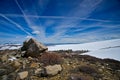 Rocks Under a Contrail Sky Royalty Free Stock Photo