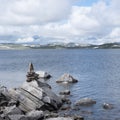 rocks and water of lake on hardangervidda in norway Royalty Free Stock Photo