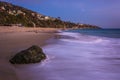 Rocks and waves in the Pacific Ocean at twilight Royalty Free Stock Photo