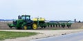 ROCKTON, ILLINOIS - APRIL 22,2020: A John Deere tracked tractor with corn planter getting ready to plant field Royalty Free Stock Photo