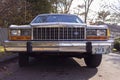 Low angle front view of a white vintage Ford Crown Victoria full size sedan car