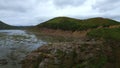 Rocky bay with swampy water. Clip. Amazing natural landscape with rocks in swampy sea bay. Rocky sea bay with algae