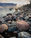 Rocky beach with an abundance of stones and the glistening waters in the backdrop