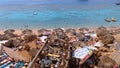 Rocky Beach with Arabic Cafes in Retro Style on the Red Sea Coast with Umbrellas, Sun Beds and Corals. Egypt