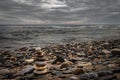 Rocky beach Boulder at the edge of the sea. Tower of stones on the beach