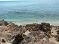 A rocky beach with clear turquoise water in Stuart, FL Royalty Free Stock Photo