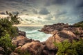 Rocky beach lagoon tropical scenery with palm trees and round stones with sunset sky vibrant colors in Sri Lanka Royalty Free Stock Photo