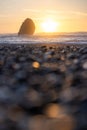 A rocky beach with a large rock in the foreground Royalty Free Stock Photo