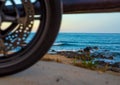 Rocky beach with motorcycle wheel in the foreground