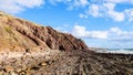 A rocky beach with rough cliffs and terrain at the sea on a sunny day in Hallet Cove, Australia Royalty Free Stock Photo