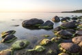 Rocky beach at sunset with milky water Royalty Free Stock Photo