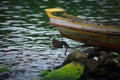 A boat harbored on rocky beach of Toba Lake in North Sumatra, Indonesia