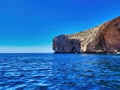 A rocky beach under the blue sky. Island is full of volcanic rocks and turqoise waters. Summer boat trip on the beach. Rocky point Royalty Free Stock Photo