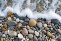 A rocky beach where a wave is seen approaching the shore, creating a dynamic and powerful scene, A gentle impacting view of waves