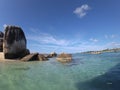 Rocky big stone on crystal clear blue beautiful beach Royalty Free Stock Photo