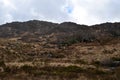 Rocky Brush Covered Landscape Leading to Hills in Ireland