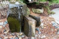 A rocky bubbling water fountain in a courtyard garden Royalty Free Stock Photo