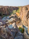 Rocky canyon with green bushes and trees in Palmwag Concession, Namibia, Southern Africa