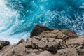Rocky Cliff Contrast From Above with Crashing Blue Water Whitecaps Perspective Royalty Free Stock Photo