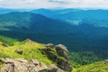 Rocky cliff on a grassy slope above the valley