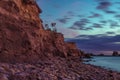 Rocky cliff near the beautiful sea under the breathtaking cloudy sky Royalty Free Stock Photo