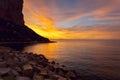 Rocky cliff surrounded by Mediterranean Sea during sunrise. Calpe, Spain Royalty Free Stock Photo