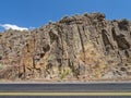 Rocky cliffs abut State Highway 225 north of Elko, Nevada, USA