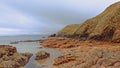 Cliffs and beach along rock coast of howth , ireland