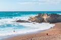 Rocky cliffs, sandy beach, and people enjoying beautiful sunny day. Montana de Oro State park, Los Osos, California Central Coast Royalty Free Stock Photo