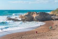 Rocky cliffs, sandy beach, and people enjoying beautiful sunny day. Montana de Oro State park, Los Osos, California Central Coast Royalty Free Stock Photo