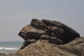 Rocky cliffs and the wavy ocean under the blue sky Royalty Free Stock Photo