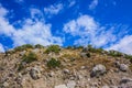 Rocky climb up the mountain and blue sky with clouds