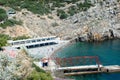 Rocky coast of the Black Sea, in the bay sunbathe and swim resting people.